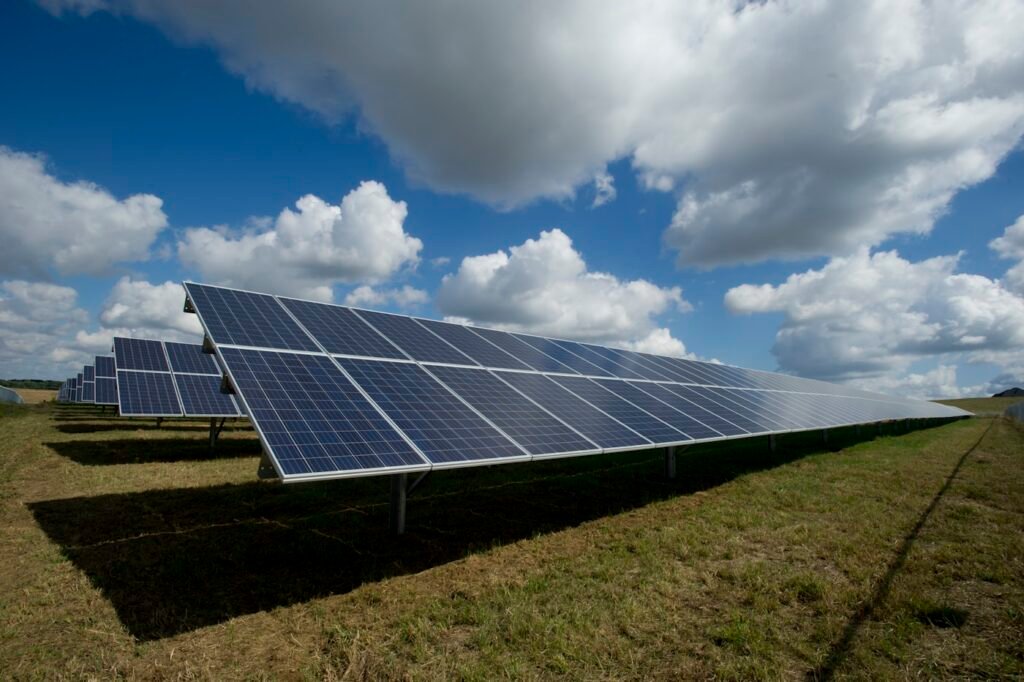 Rows of solar panels under a blue sky at a photovoltaic power plant
