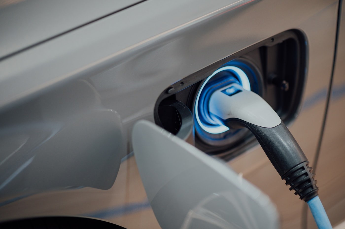 Electric vehicle charging plug inserted into a car charge port